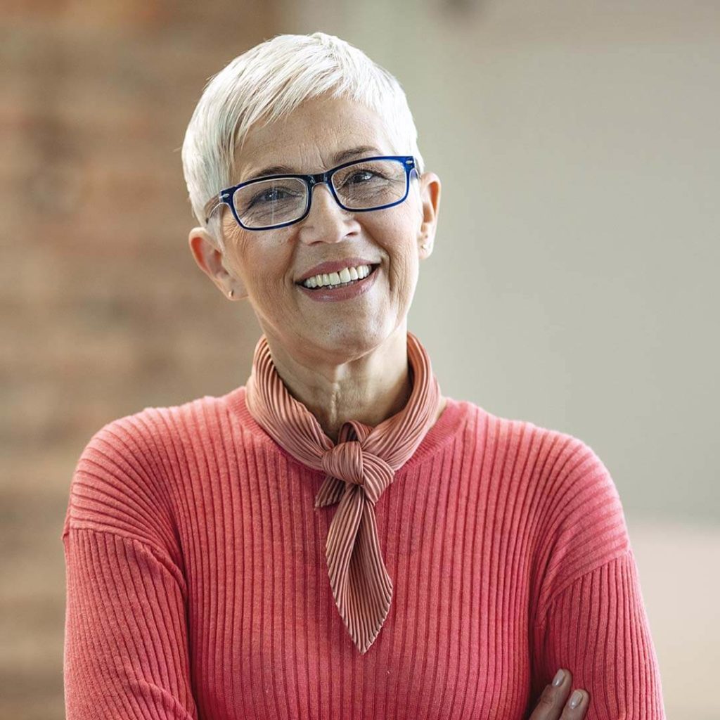 White woman with short hair smiling